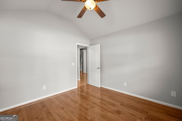 unfurnished room featuring vaulted ceiling, hardwood / wood-style flooring, and ceiling fan