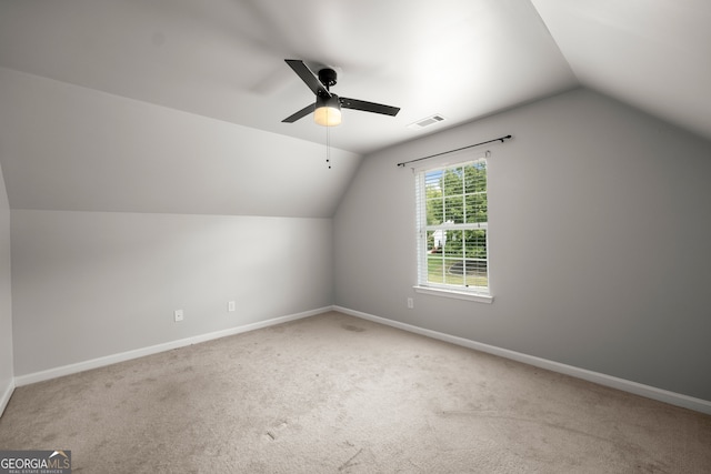 additional living space featuring ceiling fan, carpet, and vaulted ceiling