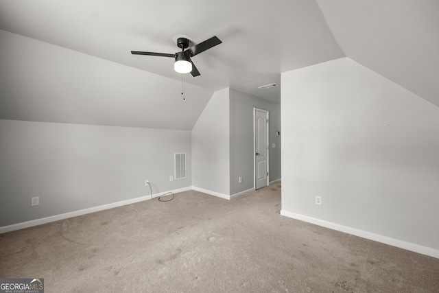 additional living space with lofted ceiling, light colored carpet, and ceiling fan