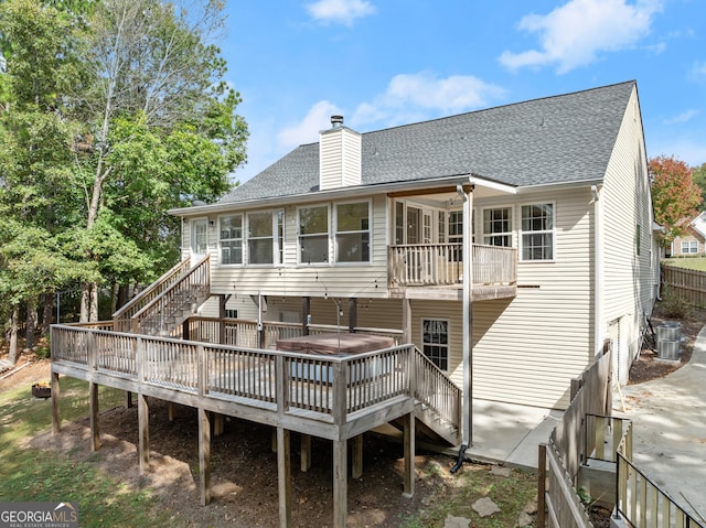 rear view of house with a wooden deck