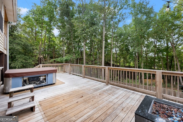 wooden terrace with an outdoor fire pit