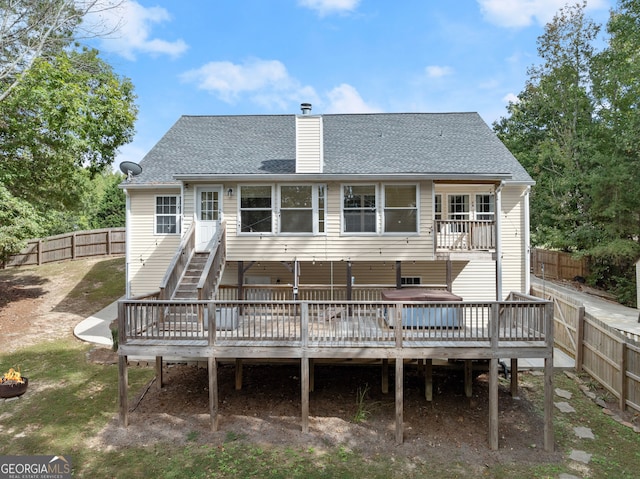 rear view of house with a wooden deck