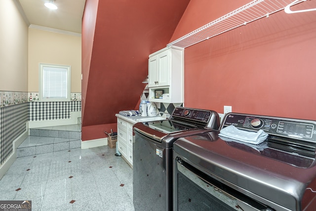 laundry room with tile walls, crown molding, independent washer and dryer, and cabinets