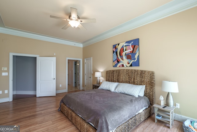 bedroom with ornamental molding, hardwood / wood-style flooring, and ceiling fan