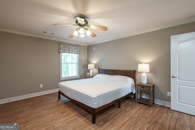 bedroom with ornamental molding, light hardwood / wood-style flooring, and ceiling fan