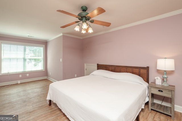 bedroom with light hardwood / wood-style floors, ornamental molding, and ceiling fan