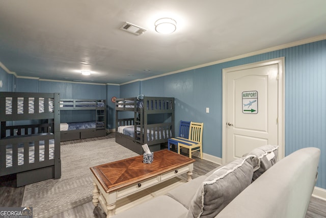 bedroom featuring hardwood / wood-style flooring and ornamental molding