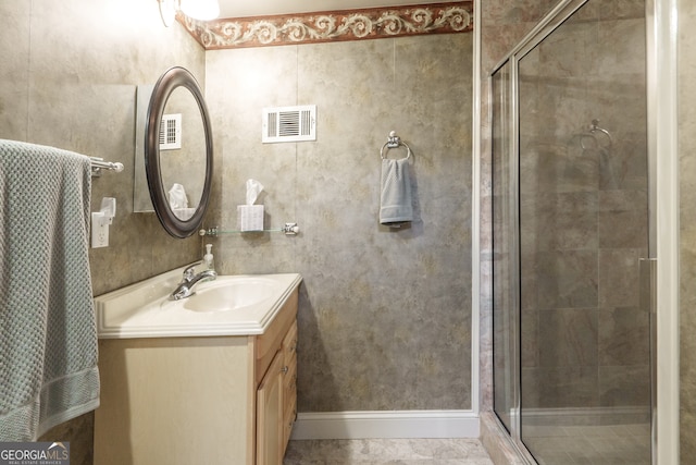 bathroom with vanity, tile patterned flooring, and a shower with door