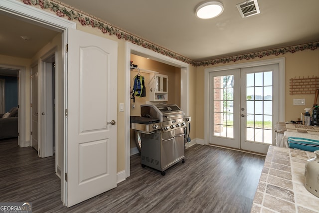 doorway featuring french doors and dark hardwood / wood-style flooring