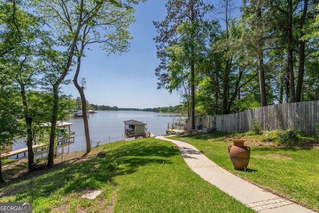 view of yard featuring a dock and a water view