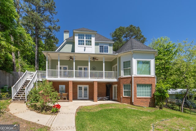 rear view of property with french doors, ceiling fan, a lawn, and a patio area