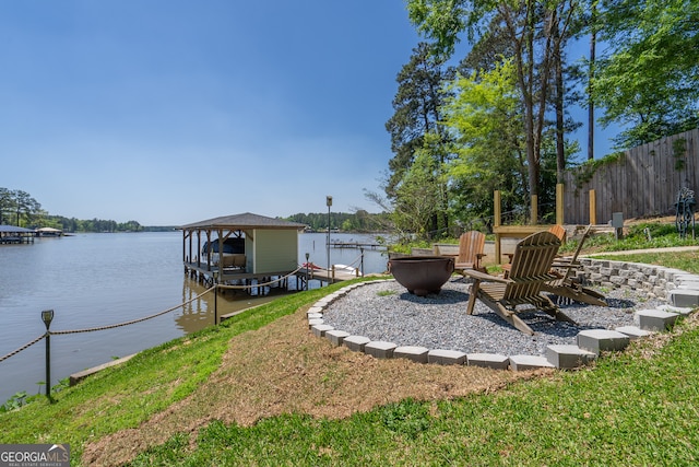 view of dock featuring an outdoor fire pit and a water view