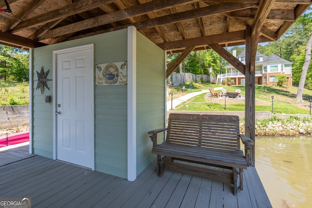 exterior space featuring a yard and a deck with water view