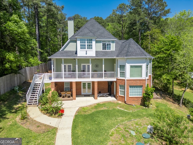 rear view of property featuring a patio area and a yard