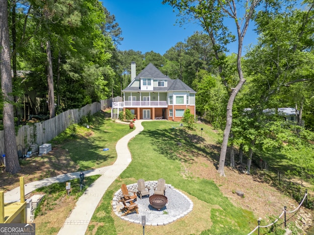 exterior space featuring a patio, a lawn, and a fire pit