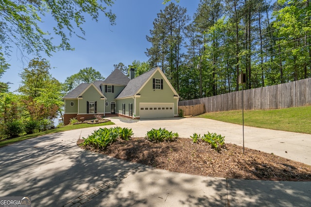 view of front of property featuring a front yard and a garage