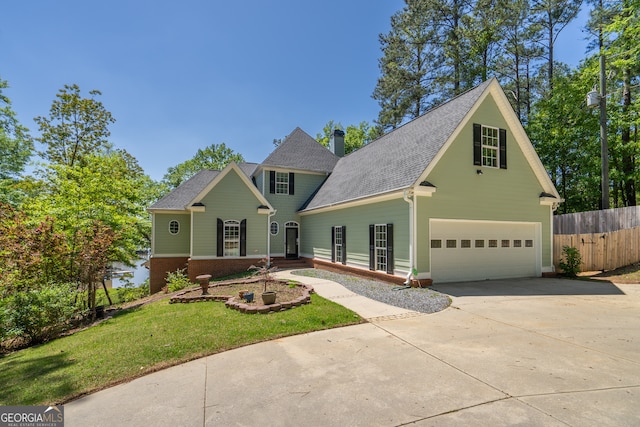 front of property featuring a front lawn and a garage