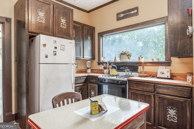 kitchen with dark brown cabinetry, range with gas stovetop, ornamental molding, and white fridge