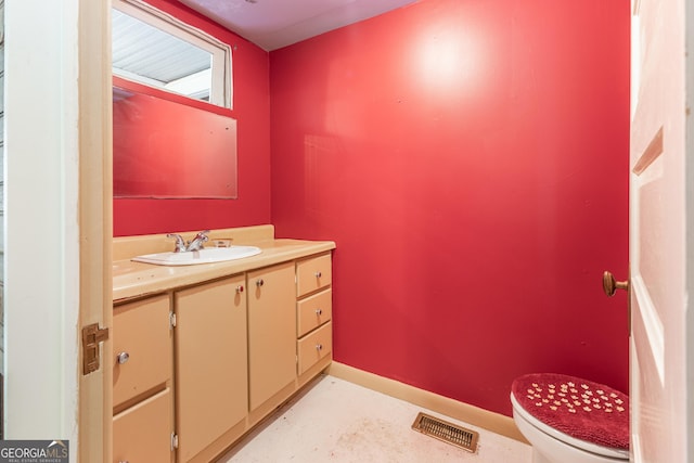 bathroom with toilet and vanity