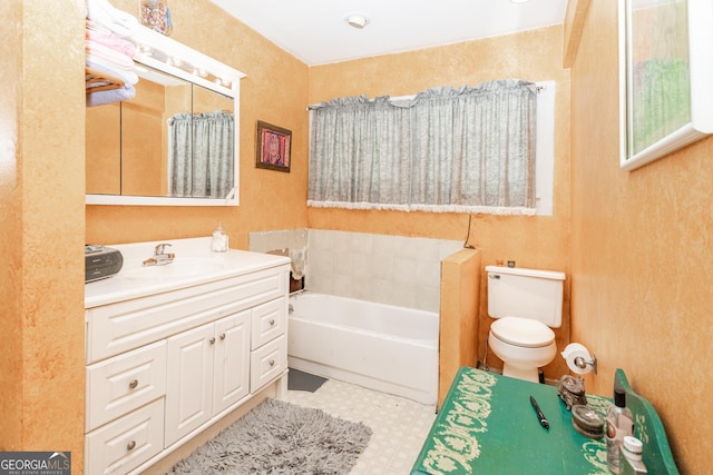 bathroom with a tub, toilet, and vanity