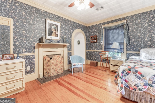 bedroom with ceiling fan, crown molding, and light hardwood / wood-style floors