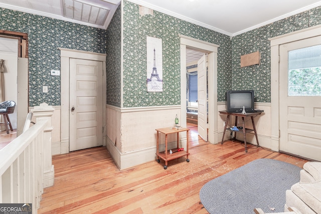 entrance foyer featuring wood-type flooring and crown molding