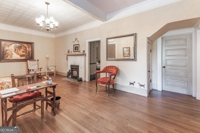 interior space with hardwood / wood-style flooring, ornamental molding, and an inviting chandelier