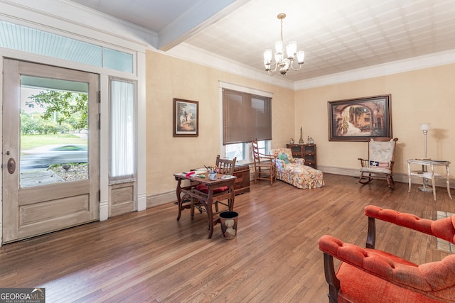 sitting room featuring an inviting chandelier, ornamental molding, and hardwood / wood-style flooring