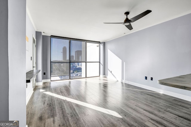 unfurnished living room with crown molding, wood-type flooring, a wall of windows, and ceiling fan