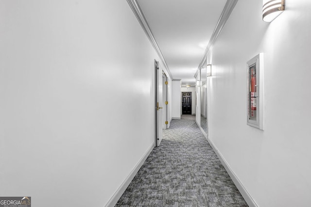 corridor with crown molding and carpet