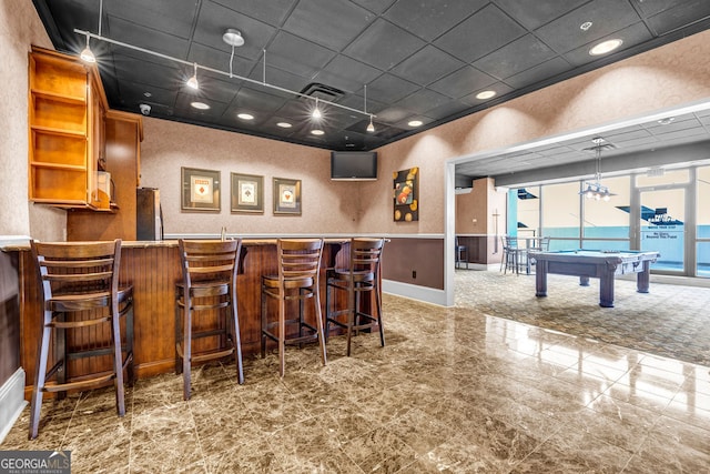 bar featuring pool table, stainless steel fridge, and hanging light fixtures