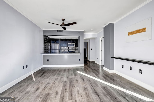 unfurnished living room featuring ornamental molding, wood-type flooring, and ceiling fan