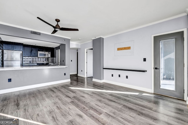 unfurnished living room featuring ceiling fan, ornamental molding, and light hardwood / wood-style flooring