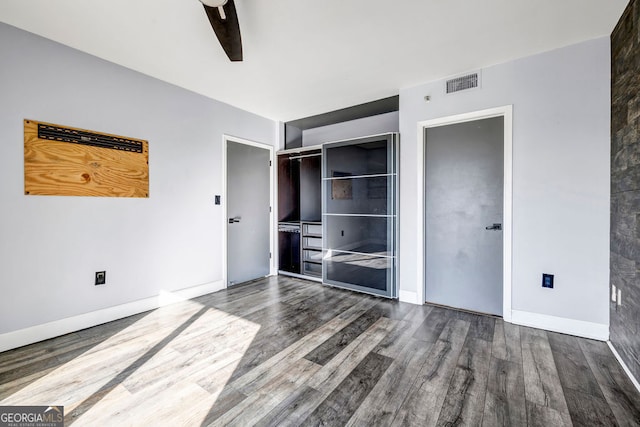 unfurnished bedroom with hardwood / wood-style floors, a closet, and ceiling fan