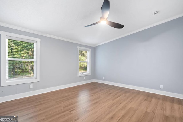 spare room with light hardwood / wood-style floors, crown molding, and ceiling fan