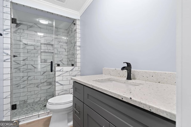 bathroom with wood-type flooring, an enclosed shower, toilet, vanity, and crown molding