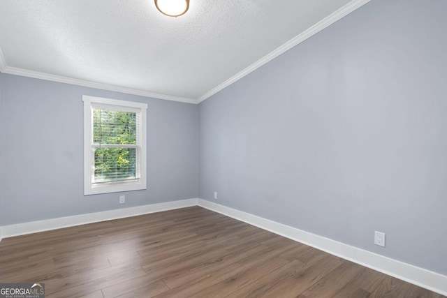 spare room with crown molding, a textured ceiling, and dark hardwood / wood-style flooring