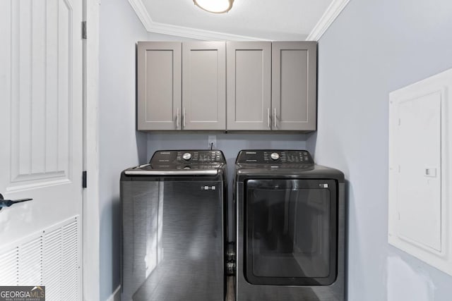 laundry room with cabinets, ornamental molding, electric panel, and separate washer and dryer