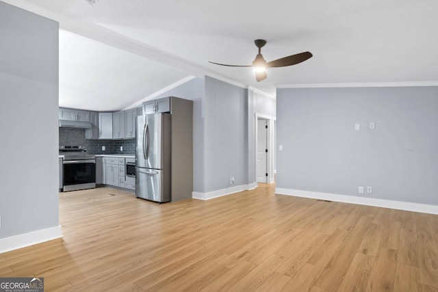 kitchen with gray cabinetry, appliances with stainless steel finishes, decorative backsplash, light hardwood / wood-style floors, and ornamental molding