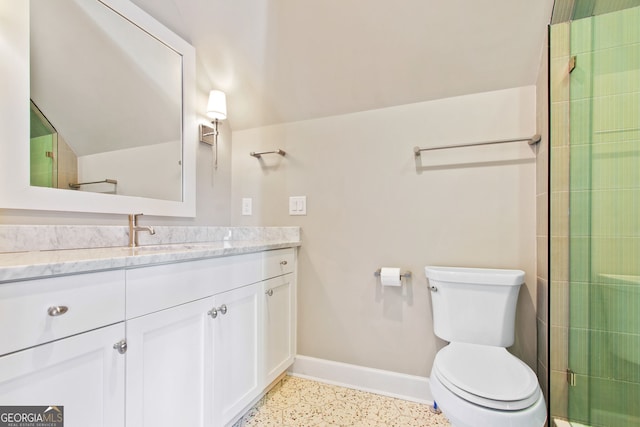 bathroom with vanity, toilet, and a shower with door