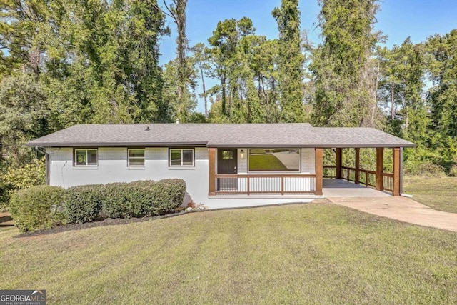 ranch-style home with a carport, covered porch, and a front lawn