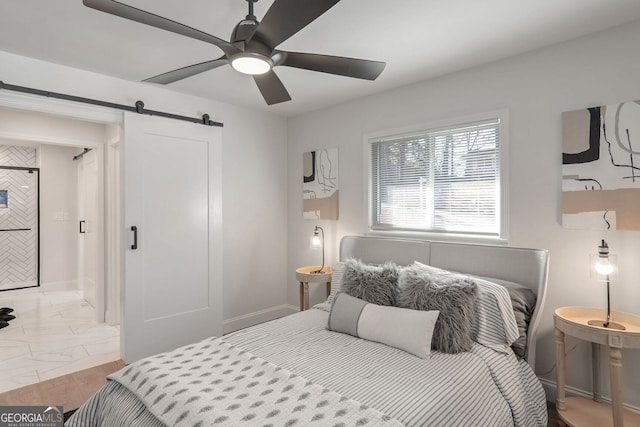 bedroom featuring a barn door and ceiling fan