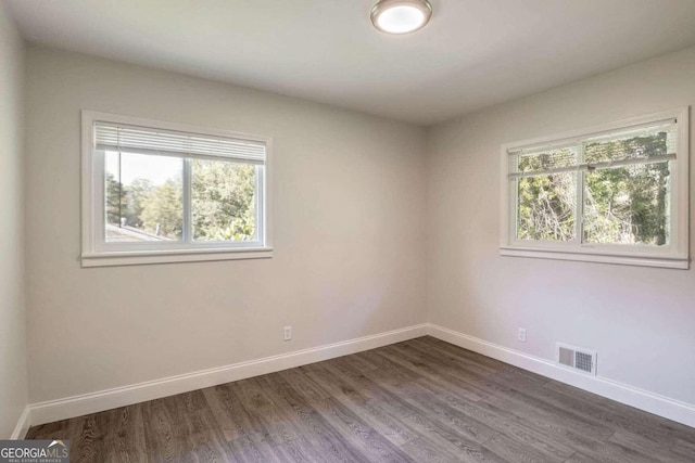 empty room with dark hardwood / wood-style floors