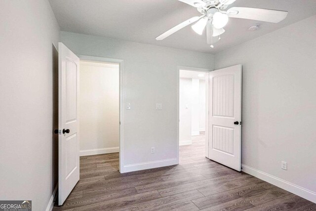 unfurnished bedroom with hardwood / wood-style flooring and ceiling fan