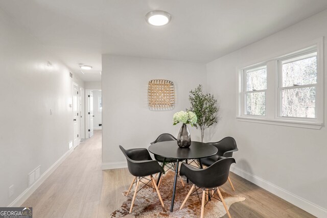 dining area with light hardwood / wood-style flooring