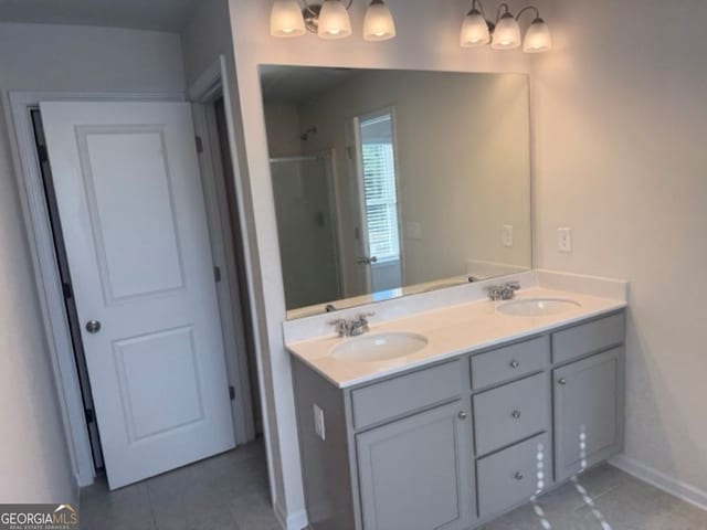 bathroom featuring walk in shower, vanity, and tile patterned flooring