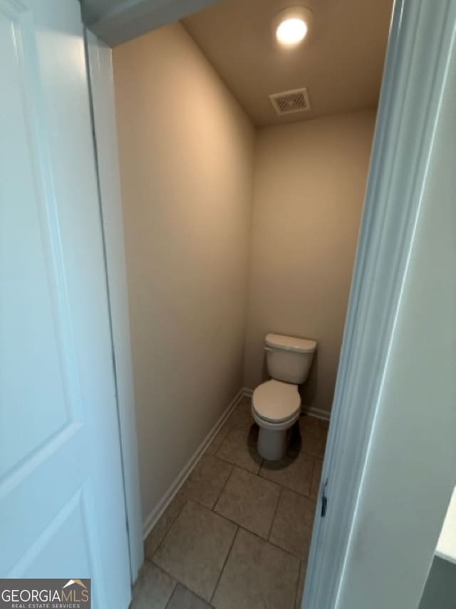 bathroom with tile patterned floors and toilet