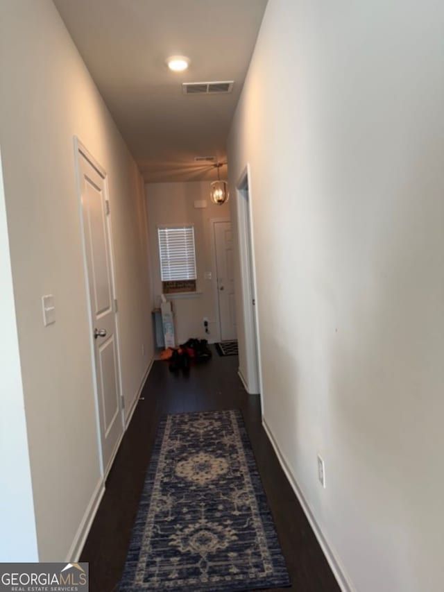 corridor with dark wood-type flooring