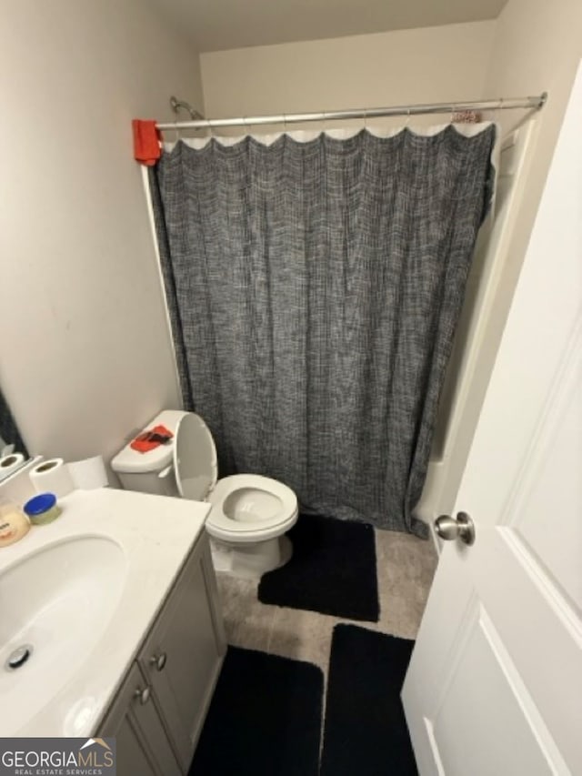 full bathroom featuring tile patterned flooring, vanity, toilet, and shower / bath combination with curtain