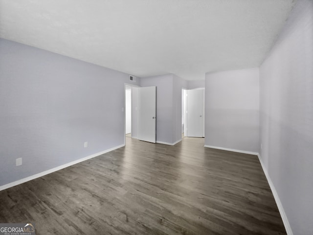 empty room featuring dark hardwood / wood-style flooring